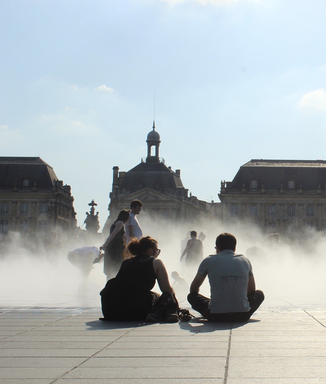 Students sitting close to the Miroir d'Eau in Bordeaux