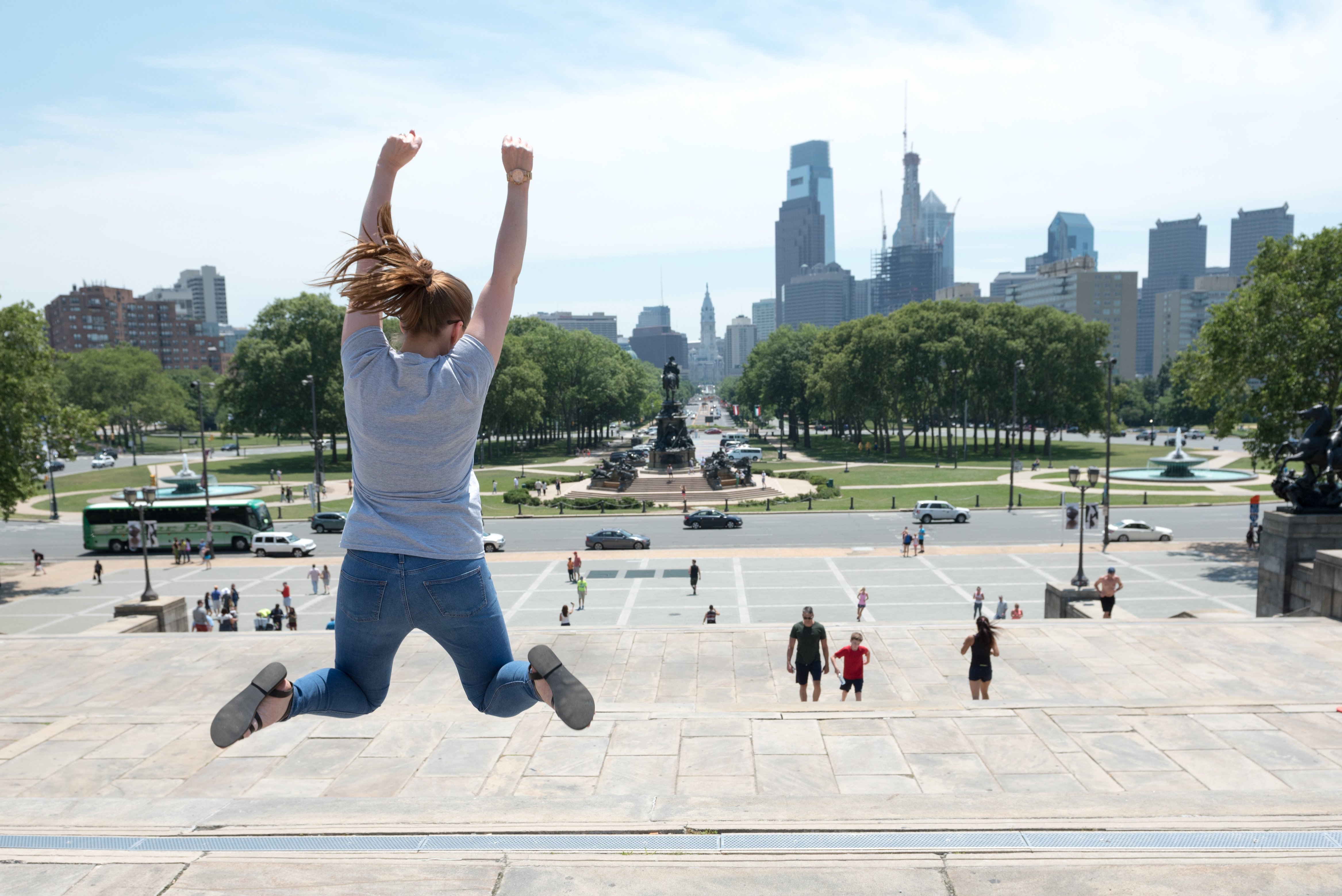 Student jumping atop Rocky Steps in Philadelphia
